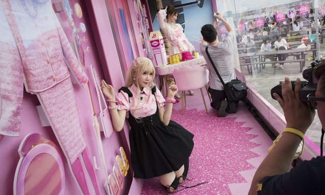 In Taipei, Taiwan, Jiang Zong-Young (front left) photographs a woman affectionately known as QQE (front right) inside a Barbie promotional truck, heralding the arrival of the much-anticipated movie in Taiwan theaters on July 20, 2023. (Photo by Brennan O'Connor/ZUMA Press Wire/Rex Features/Shutterstock)