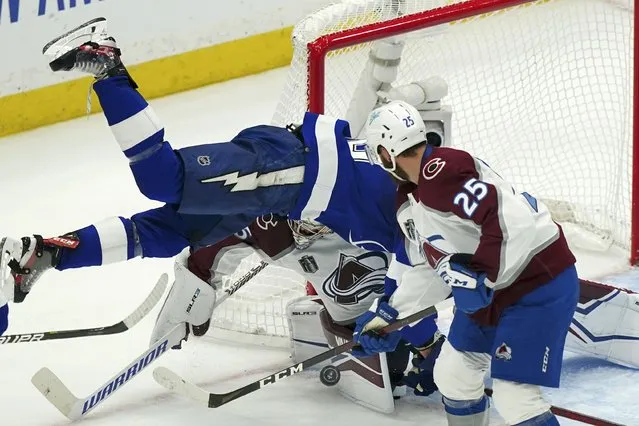 Tampa Bay Lightning right wing Corey Perry falls in front of Colorado Avalanche goaltender Darcy Kuemper (35) as Kuemper blocks a shot during the first period of Game 4 of the NHL hockey Stanley Cup Finals on Wednesday, June 22, 2022, in Tampa, Fla. (Photo by John Bazemore/AP Photo)