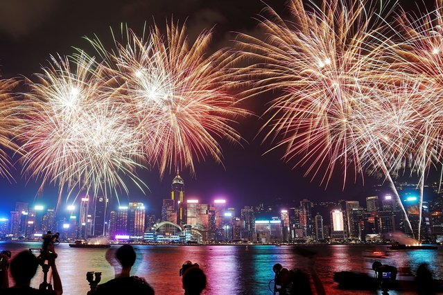 Fireworks light up over Victoria Harbour to celebrate the 75th anniversary of China's National Day, in Hong Kong, China on October 1, 2024. (Photo by Lam Yik/Reuters)