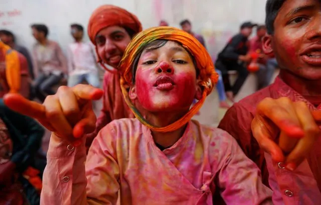 Hindu devotees take part in the religious festival of Holi inside a temple in Nandgaon village, in the state of Uttar Pradesh, India, March 5, 2020. (Photo by Adnan Abidi/Reuters)