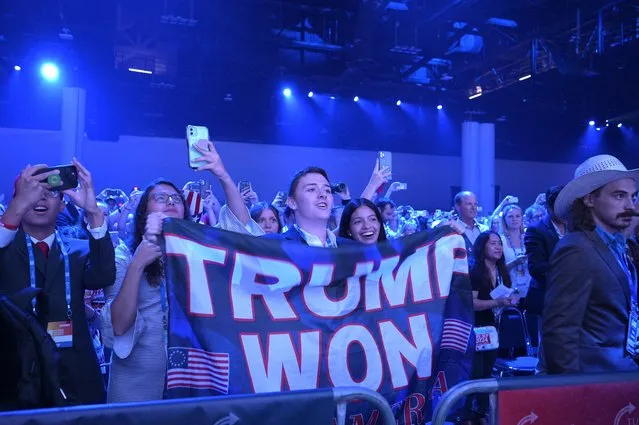 Attendees display a flag as former President Donald Trump takes the stage during the Turning Point USA Student Action Summit, Saturday, July 23, 2022, in Tampa, Fla. (Photo by Phelan M. Ebenhack/AP Photo)