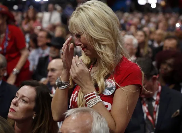 A delegate weeps during a speech by Pat Smith, whose son Sean was killed in the attacks on Benghazi, Libya in 2012, at the Republican National Convention in Cleveland, Ohio, U.S. July 18, 2016. (Photo by Jonathan Ernst/Reuters)