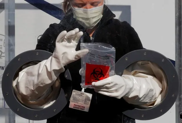 Physician Assistant Cori Kostick demonstrates the Brigham B-PROTECTED testing booth used to administer tests for the coronavirus disease (COVID-19) at the Brigham and Women Hospital's community testing site in Boston, Massachusetts, U.S., May 5, 2020. (Photo by Brian Snyder/Reuters)