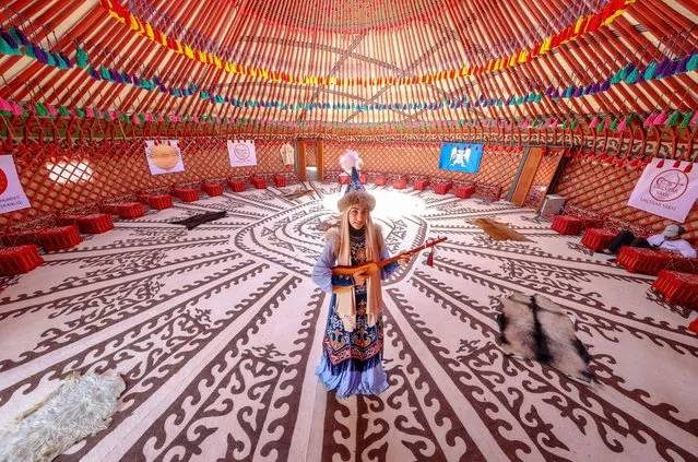 A woman wears traditional costumes at the event area held for 951th anniversary of Victory of Malazgirt (1071 Battle of Manzikert) at the Carho neighbourhood where “1071 Sultan Alparslan Ahlat Otagi” was established, at Nation's Garden in Ahlat district of Bitlis, Turkiye on August 23, 2022. 51 thematic tents promoting the traditions and customs of the provinces were set u and also the team from Azerbaijan opened a photography exhibition reflecting the Karabakh Victory and introduced their culture to the visitors. (Photo by Ozkan Bilgin/Anadolu Agency via Getty Images)