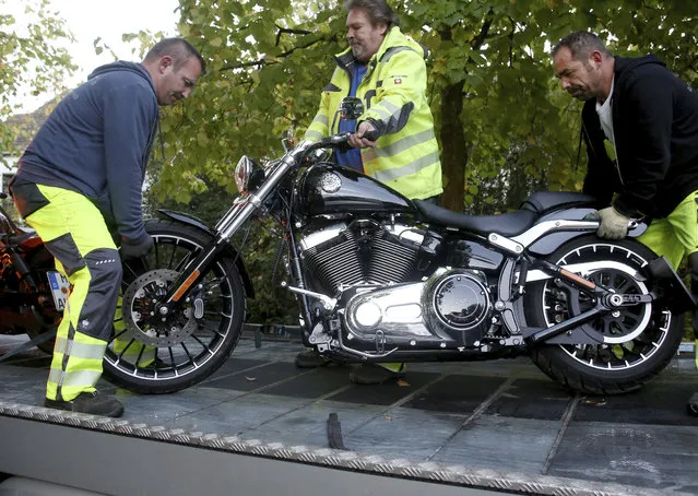 A motorcycle of a member of the Hells Angels is being seized in Erkrath, western Germany, Wednesday, October 18, 2017. More than 700 German police raided buildings used by a local chapter of the Hells Angels biker gang near the western city of Duesseldorf after state authorities banned the group on suspicion it was engaged in a wide range of criminal activity. (Photo by Roland Weihrauch/DPA via AP Photo)
