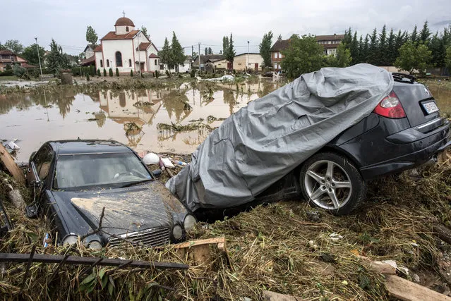 Damaged vehicles swept into a field in the village of Stajkovci, Skopje, The Former Yugoslav Republic of Macedonia on 07 August 2016. At least 15 people have died in a rain storm that hit the Macedonian capital Skopje late on 06 August 2016 causing severe damage to roads, houses and infrastructure. Around 80 vehicles were caught in landslides the hit Skopje's ringroad which remains closed. (Photo by Georgi Licovski/EPA)