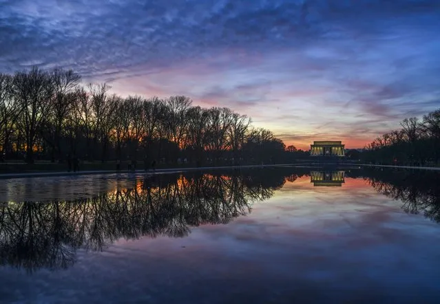 The sun sets behind the Lincoln Memorial and the Reflecting Pool in Washington, D.C. on December 26, 2019. (Photo by Jonathan Newton/The Washington Post)