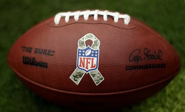 A football with a Salute to Service emblem rests on the field in Houston. (Photo by Eric Gay/Associated Press)