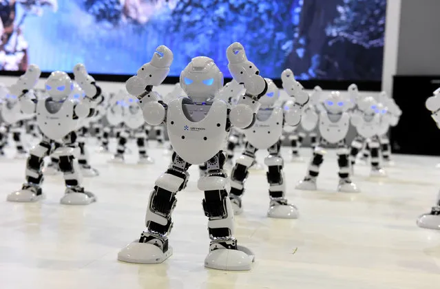 Over 50 robots dance during the opening ceremony of the sixth Shandong Cultural Industries Fair (SDCIF) at Jinan International Convention & Exhibition Center on August 25, 2016 in Jinan, Shandong Province of China.The 50 robots are named 'Alpha' and are connected to cellphones instructing them to perform different actions according to various musical sounds. (Photo by VCG/Getty Images)