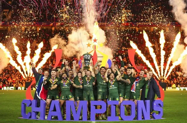 Australia's players celebrate with the trophy after winning during the Rugby League World Cup final match between Australia and Samoa at the Old Trafford Stadium in Manchester, England, Saturday, November 19, 2022. (Photo by Jon Super/AP Photo)