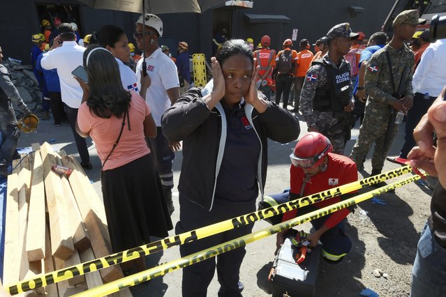 A woman stands outside the Jet Set nightclub after its roof collapsed during a merengue concert in Santo Domingo, Dominican Republic, Tuesday, April 8, 2025. (Photo by Ricardo Hernandez/AP Photo)