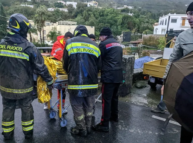 A man injured by the landslide is rescued by firefighters in Casamicciola, Ischia Island, Southern Italy, 26 November 2022. Thirteen people went missing on 26 November after heavy rains caused a landslide on the Italian island of Ischia. (Photo by ANSA/EPA/EFE)