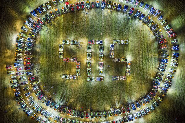 Farmers form a giant “SOS” distress signal with their tractors as coordinated stunt replicated in various locations across the country, in a field between the villages of Echallens and Goumoens-la-Ville, Switzerland, 29 February 2024. Farmers are protesting against their work conditions and here specifically the price of milk, echoing numerous protests across Europe in the recents weeks. (Photo by Valentin Flauraud/EPA)