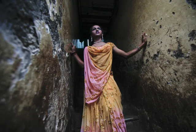 Bhoomi, an eunuch stands at an alley stairwell as she watches Raksha Bandhan festival celebrations in a red light area in Mumbai August 12, 2011. (Photo by Danish Siddiqui/Reuters)