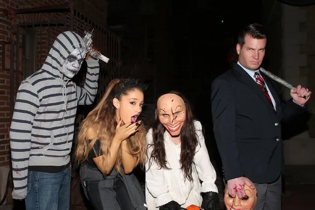 In this handout photo provided by Universal Orlando, pop music sensation Ariana Grande bravely roamed the terrifying streets of Halloween Horror Nights 24 at Universal Orlando Resort with her family and friends on October 30, 2014 in Orlando, Florida. During her visit, Grande's worst nightmares became reality as she came face-to-face with the iconic masked vigilantes in the frightening street experience, “The Purge: Anarchy”. (Photo by Jones Crow/Universal Orlando Resort via Getty Images)