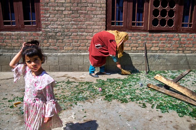 A Kashmiri woman clears shattered glass outside her home after it was damaged in a blast at the house of Asif Sheikh, who officials say is a militant and have blamed for involvement in the deadly attack on tourists in Pahalgam, at Monghama village in Tral, south of Srinagar, Indian controlled Kashmir, Friday, April 25, 2025. (Photo by Dar Yasin/AP Photo)