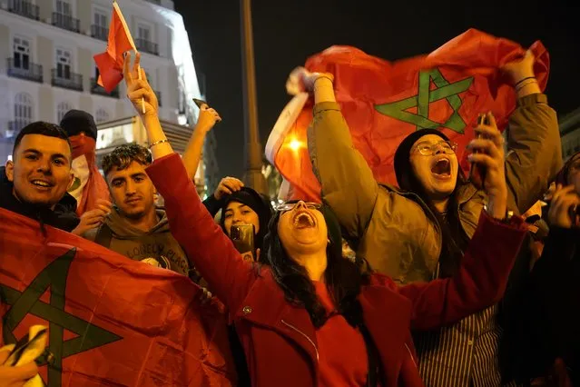 Morocco fans celebrate in the central Puerta del Sol in Madrid, Spain, Tuesday, December 6, 2022. Morocco beat Spain on penalties during a round of 16 World Cup soccer tournament in Qatar. (Photo by Andrea Comas/AP Photo)