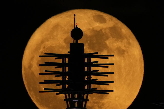 Artwork atop the Kansas City Convention Center is silhouetted against the rising full moon Monday, May 12, 2025, in Kansas City, Mo. (Photo by Charlie Riedel/AP Photo)