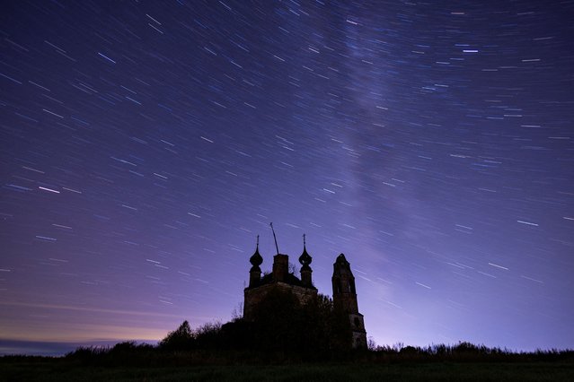 An abandoned church is seen under a starry sky outside of the settlement of Semibratovo, Yaroslavl region, Russia, on October 5, 2024. Picture taken with long exposure. (Photo by Maxim Shemetov/Reuters)