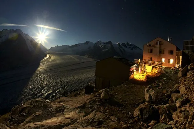 Hikers get ready under the full moon at the Konkordia Hut above the Aletsch Glacier at Konkordia Place, Switzerland, August 29, 2015. (Photo by Denis Balibouse/Reuters)