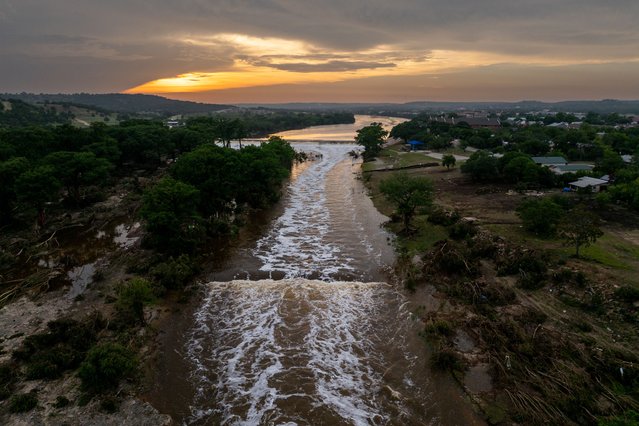 In an aerial view, the sun sets over the Guadalupe River on July 06, 2025 in Kerrville, Texas. Heavy rainfall caused severe flooding along the Guadalupe River in central Texas, leaving more than 80 people reported dead. (Photo by Brandon Bell/Getty Images)