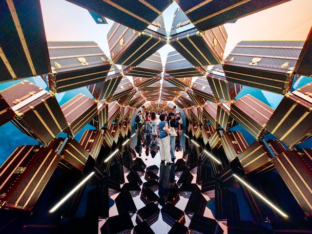 People visit the “The Louis”, Louis Vuitton's new multi-sensory flagship store shaped like a ship, on July 2, 2025 in Shanghai, China. Taking the shape of a magnificent boat, “the Louis” boasts a 1,600-square-meter three-story experience space, with a length of 114.5 meters and 30 meters in height, consisting of retail, Le Cafe Louis Vuitton and a Louis Vuitton Visionary Journeys exhibition. It opened on June 28 as the brand's only nautically-inspired architectural landmark. (Photo by VCG/VCG via Getty Images)