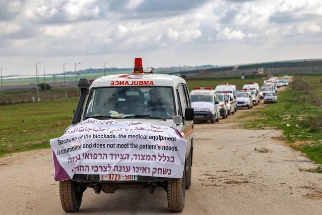 A convoy of Palestinian ambulance vehicles moves along the border fence between Israel and the Gaza Strip east of Gaza City on January 9, 2023, during a protest against Israel's prevention of allowing diagnositc medical equipment to enter hospitals in the Palestinian enclave. (Photo by Mohammed Abed/AFP Photo)