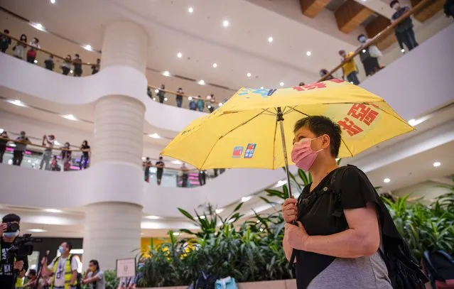 A protester wearing a facemask is seen holding a democracy umbrella during the protest to commemorate the 6th anniversary of Umbrella movement on September 28, 2020. Dozens of pro-democracy protesters gathered at the Pacific Place shopping mall in Hong Kong to mark the 6th anniversary of Umbrella movement where Hong Kongers took to the street and occupied the major roads in the city to demand for universal suffrage. (Photo by May James/SOPA Images/LightRocket via Getty Images)