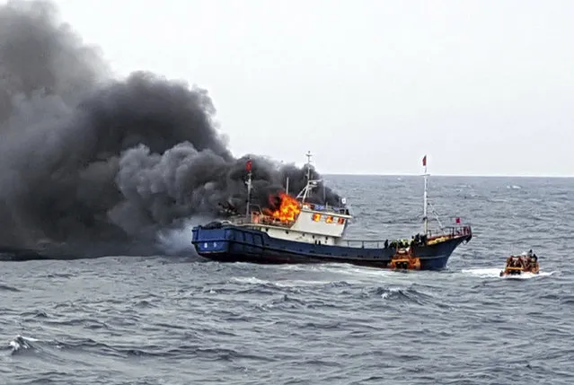 In this Thursday, September 29, 2016 photo provided by the South Korean Mokpo Coast Guard, a Chinese fishing boat catches fires during an inspection by the South Korean coast guard in the water off Hong Island, South Korea. South Korea’s coast guard said three Chinese fishermen have been found dead when a fire broke out on their boat after the coast guard fired a flashbang grenade at the vessel to stop it. (Photo by South Korean Mokpo Coast Guard via AP Photo)