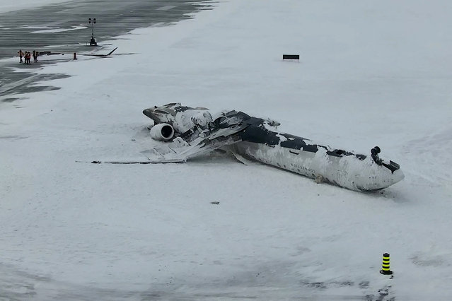A drone view of the wreckage of a Delta Air Lines operated CRJ-900 aircraft lies crashed on the runway at Toronto Pearson International Airport in Mississauga, Ontario, Canada on February 18, 2025 in a still image from video. (Photo by TSB/Handout via Reuters)