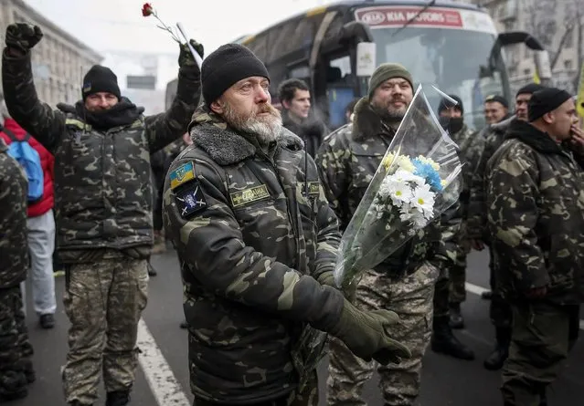 Servicemen of “Kiev 12” military defence battalion react as they take part in a welcoming ceremony in central Ukrainian capital Kiev December 6, 2014. (Photo by Gleb Garanich/Reuters)