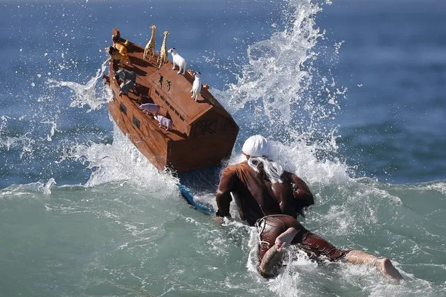 A competitor surfs as Noah with his ark during the ZJ Boarding House Haunted Heats Halloween Surf Contest in Santa Monica, California, United States, October 31, 2015. (Photo by Lucy Nicholson/Reuters)