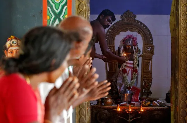 People pray for the victory of U.S. Democratic vice presidential nominee Kamala Harris inside a temple in the village of Thulasendrapuram, where Harris' maternal grandfather was born and grew up, in Tamil Nadu, India, November 4, 2020. (Photo by P. Ravikumar/Reuters)