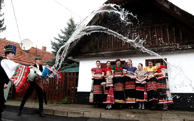 Men throw water on women as part of traditional Easter celebrations in Mezokovesd, Hungary, April 1, 2018. According to an old tradition on Easter Monday young men pour water on young women who then exchange their sprinklers containers for beautifully coloured eggs. Capital of Matyo region, Mezokoevesd and neighbouring villages in Eastern Hungary are famous for their hand- embroidered textiles, folk costumes, painted easter eggs, traditional houses and Matyo festivities. (Photo by Bernadett Szabo/Reuters)