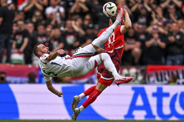 Hungary's Attila Fiola, left, and Switzerlands Ruben Vargas, right, challenge for the ball during a Group A match between Hungary and Switzerland at the Euro 2024 soccer tournament in Cologne, Germany, Saturday, June 15, 2024. (Photo by Marius Becker/dpa via AP Photo)