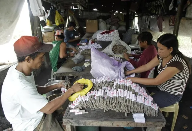 Workers makes firecrackers at a makeshift factory in Bocaue town, Bulacan province, north of Manila December 27, 2014. (Photo by Romeo Ranoco/Reuters)