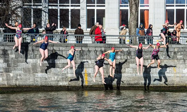 Participants enter the water during the 53th edition of the “Traversee hivernale de la Meuse” winter swimming in the Meuse River on Sunday, 27 February 2022 in Huy, Belgium. (Photo by Rex Features/Shutterstock)