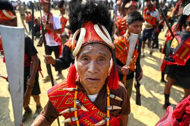 The Konyak tribe's men with guns and sickle dance at their community gathering in Longwa village, in the northeast Indian state of Nagaland on April 8, 2023. (Photo by Arun Sankar/AFP Photo)