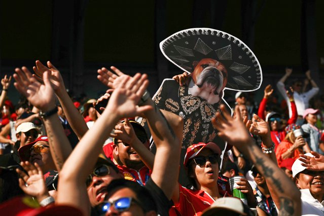 Fans show a sign depicting Roscoe, the deceased dog of Ferrari's British driver Lewis Hamilton, during the qualifying session of the Mexico City Formula One Grand Prix at the Hermanos Rodriguez racetrack in Mexico City on October 25, 2025. (Photo by Carl de Souza/AFP Photo)