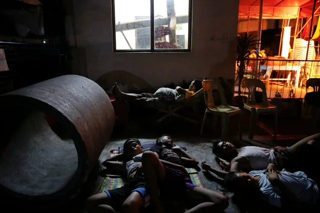 People sleep in the open in Tondo, Manila, Philippines early October 24, 2016. (Photo by Damir Sagolj/Reuters)