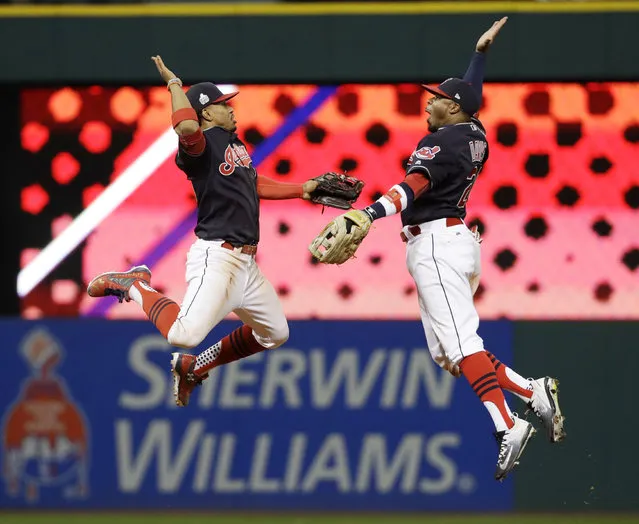 Cleveland Indians' Francisco Lindor and Rajai Davis celebrate after Game 1 of the Major League Baseball World Series against the Chicago Cubs Tuesday, October 25, 2016, in Cleveland. The Indians won 6-0 to take a 1-0 lead in the series. (Photo by Gene J. Puskar/AP Photo)