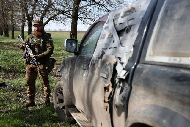 A serviceman of Ukrainian 80th separate airborne assault brigade, stands next to a car on the front line near Bakhmut in Donetsk region on April 18, 2023, amid the Russian invasion of Ukraine. (Photo by Anatolii Stepanov/AFP Photo)