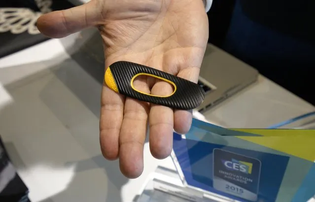 The FitLinxx AmpStrip wearable heartrate monitor is displayed at the International Consumer Electronics show (CES) in Las Vegas, Nevada January 4, 2015. The AmpStrip is designed to be comfortable enough to be worn 24/7 for constant monitoring. (Photo by Rick Wilking/Reuters)