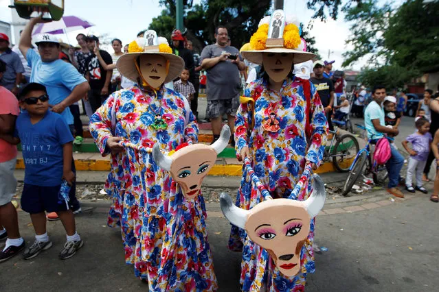 Two masked dancers pose for a photo during the annual “Torovenado del Pueblo” festival, held in honour of San Jeronimo, the patron saint of the city of Masaya, Nicaragua October 30, 2016. (Photo by Oswaldo Rivas/Reuters)