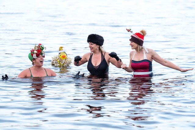 Members of the Loch Insh Dippers wild swim group take part in a Christmas-themed swim in the frozen Loch Insh, Kingussie, in the Cairngorms National Park on Friday, December 13, 2024. (Photo by Jane Barlow/PA Images via Getty Images)