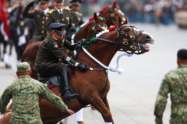 A Mexican officer rides a horse during a parade to mark the 114th anniversary of the Mexican Revolution at the Zocalo Square in Mexico City on November 20, 2024. (Photo by Raquel Cunha/Reuters)
