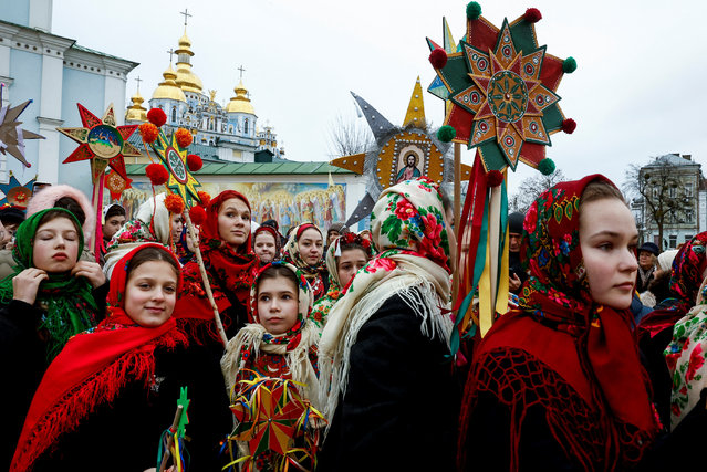 People wear traditional Ukrainian clothes as they mark Christmas Day with a carol singing event outside St. Michael's Golden-Domed Monastery, amid Russia's attack on Ukraine, in Kyiv, Ukraine, on December 25, 2024. (Photo by Thomas Peter/Reuters)