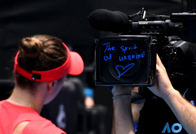 Ukraine's Elina Svitolina writes a message on a TV camera after winning her fourth-round match against Russia's Veronika Kudermetova in the Australian Open on January 20, 2025. (Photo by Jaimi Joy/Reuters)