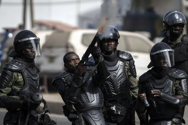 A riot policeman fires tear gas at demonstrators during protests in support of main opposition leader and former presidential candidate Ousmane Sonko in Dakar, Senegal, Wednesday, March 3, 2021. (Photo by Leo Correa/AP Photo)