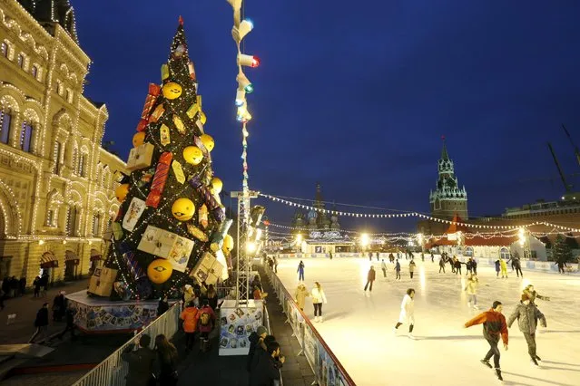 People skate near a Christmas tree in Red Square in Moscow, Russia, December 10, 2015. (Photo by Maxim Zmeyev/Reuters)